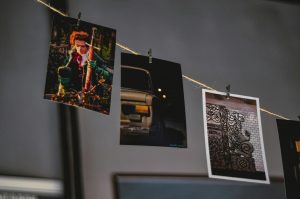 Three photo prints hanging on a string, showcasing different scenes.